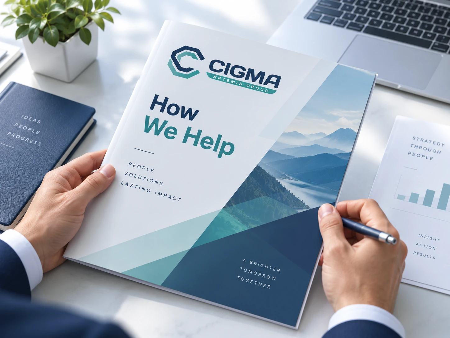 Cigma How We Help brochure with the Cigma Artemis Group logo, held above a desk